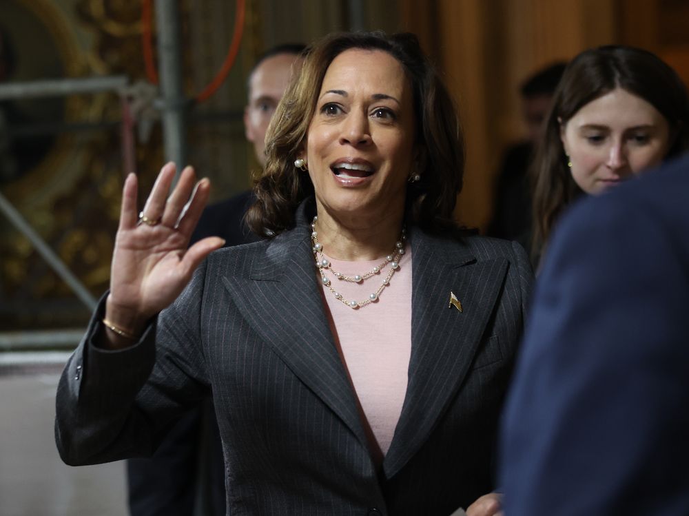 Kamala Harris waving while wearing a blazer